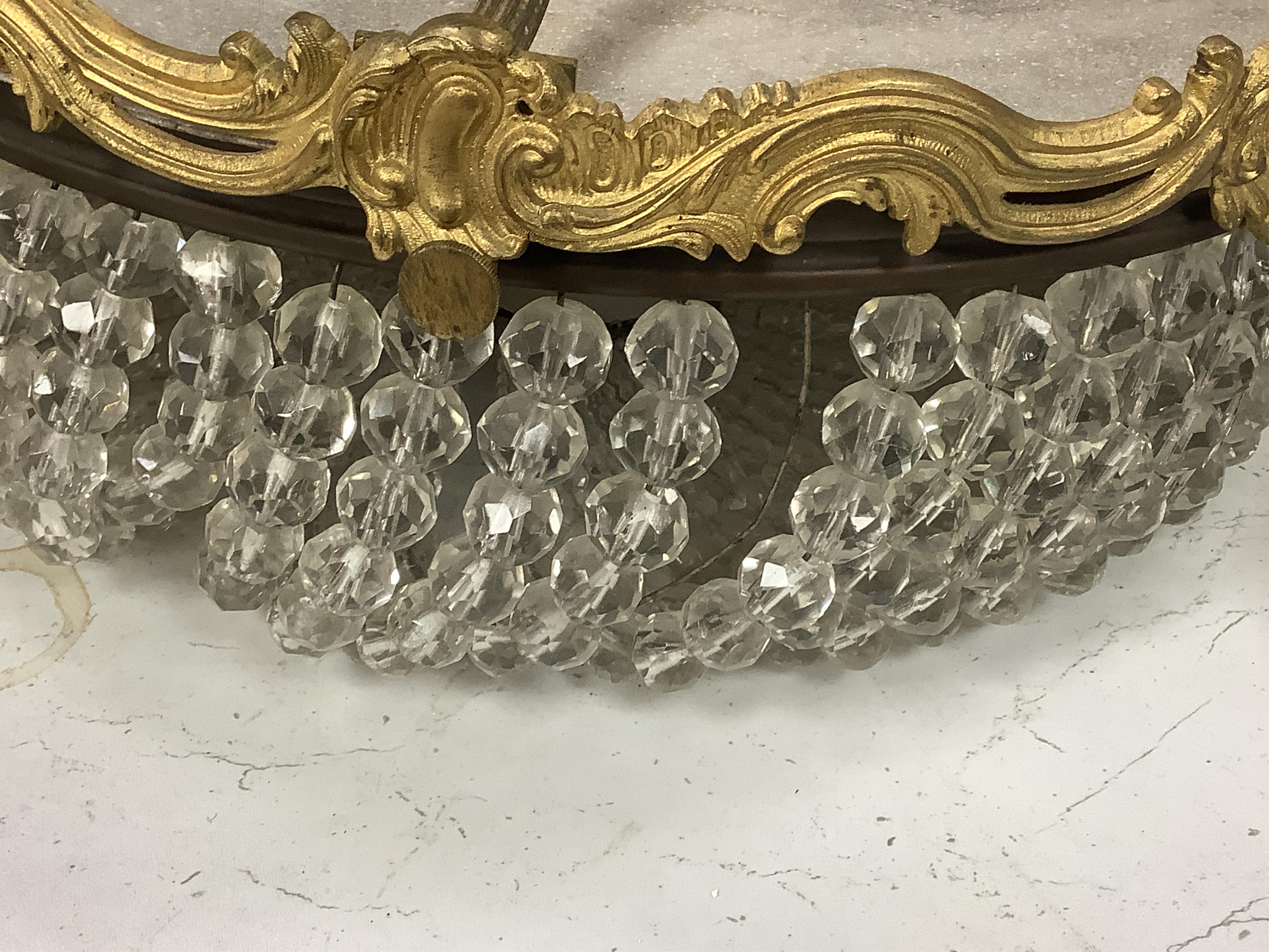 An ormolu and glass drop bag chandelier. Condition - some drops missing/loose